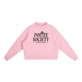 A pastel pink, long-sleeve crewneck sweatshirt with a black graphic on the chest stating: "Polite Society Certified 2026". The "I" in "Polite" is replaced with a rose and stem.