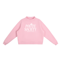 A pastel pink, long-sleeve crewneck sweatshirt with a white graphic on the chest stating: "Polite Society Certified 2026". The "I" in "Polite" is replaced with a rose and stem.
