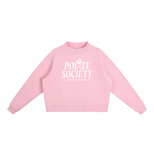 A pastel pink, long-sleeve crewneck sweatshirt with a white graphic on the chest stating: "Polite Society Certified 2026". The "I" in "Polite" is replaced with a rose and stem.